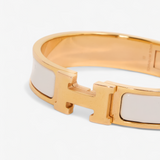 HERMÈS HERMES CLIC H GULD/HVID